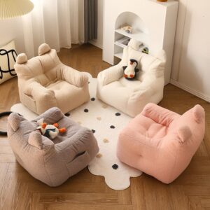 Photo de quatre petit fauteuil en peluche avec des oreilles posé dans une chambre sur un tapis, vu d'en haut.